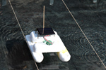 Das Foto zeigt ein kleines Boot, das aus Styropor gebaut wurde und mit einer Solarzelle, einem Motor und einer Schiffsschraube als Antrieb ausgestattet ist.